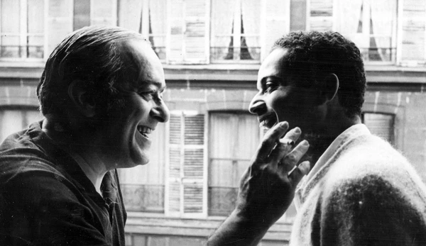 Two men share a warm smile in "Os Afro-Sambas: O Brasil de Baden e Vinícius".